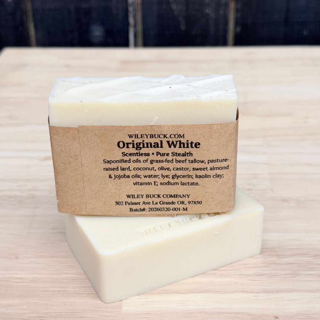 Bar of soap with a kraft paper label on a wooden surface