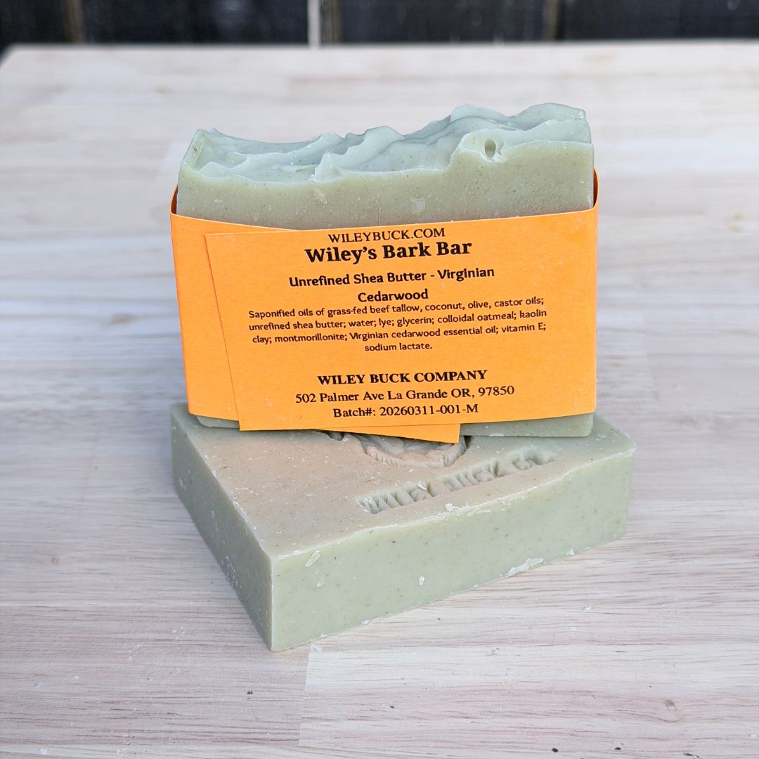 Bar of soap with an orange label on a wooden surface