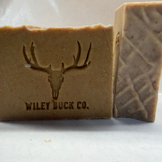 Two almond honey oat soap bars with a deer logo and 'Wiley Buck Co.' text on a white background