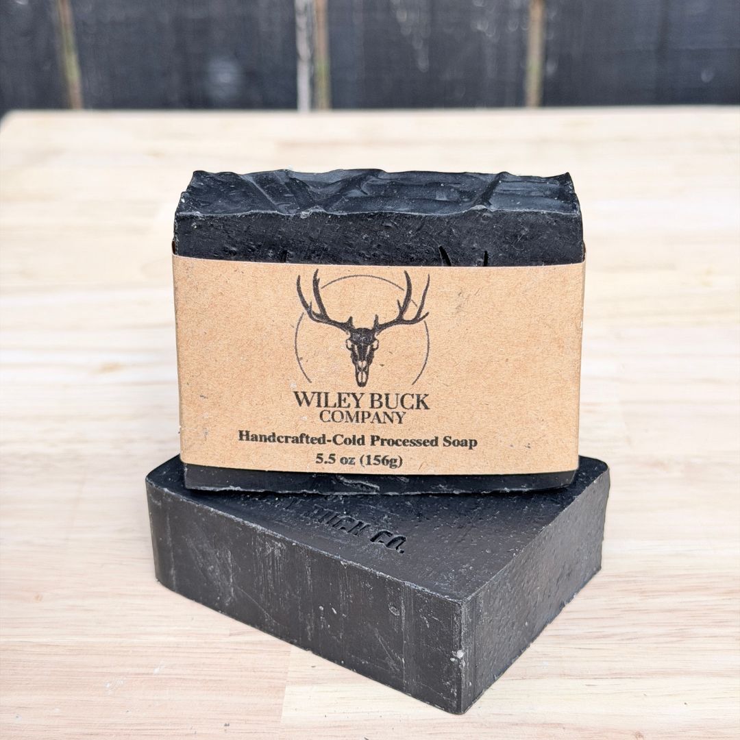 scent control collection and unscented soap bars, image shows man hunting in a dark forest with the sun coming through the trees