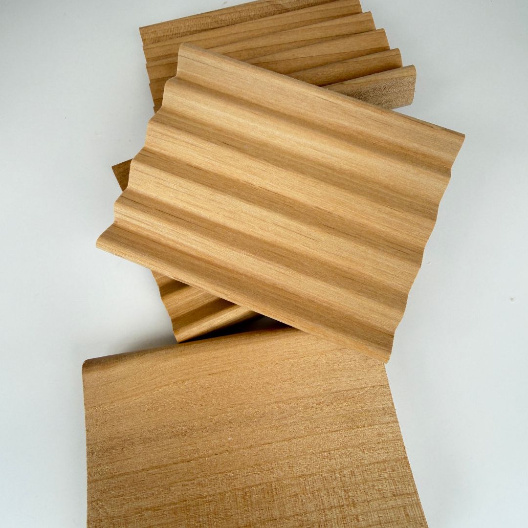 Wooden soap trays with a wavy texture on a white background