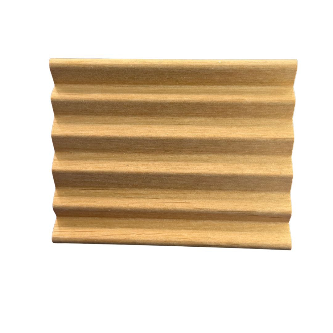 Wooden soap dish with wavy design on a white background