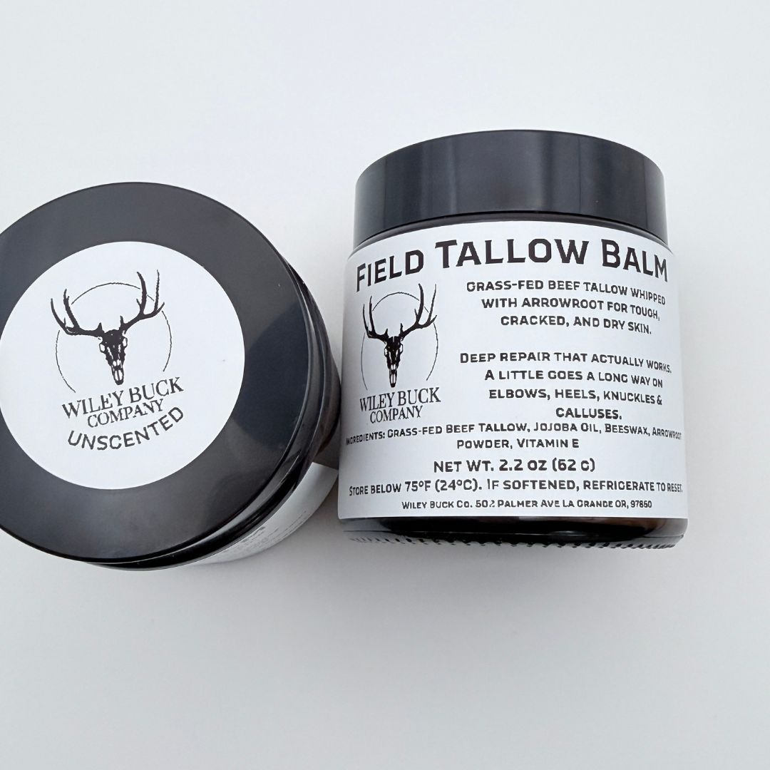Two containers of Field Tallow Balm from Wiley Buck Company on a white background
