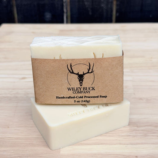 Bar of soap with a brown label on a wooden surface