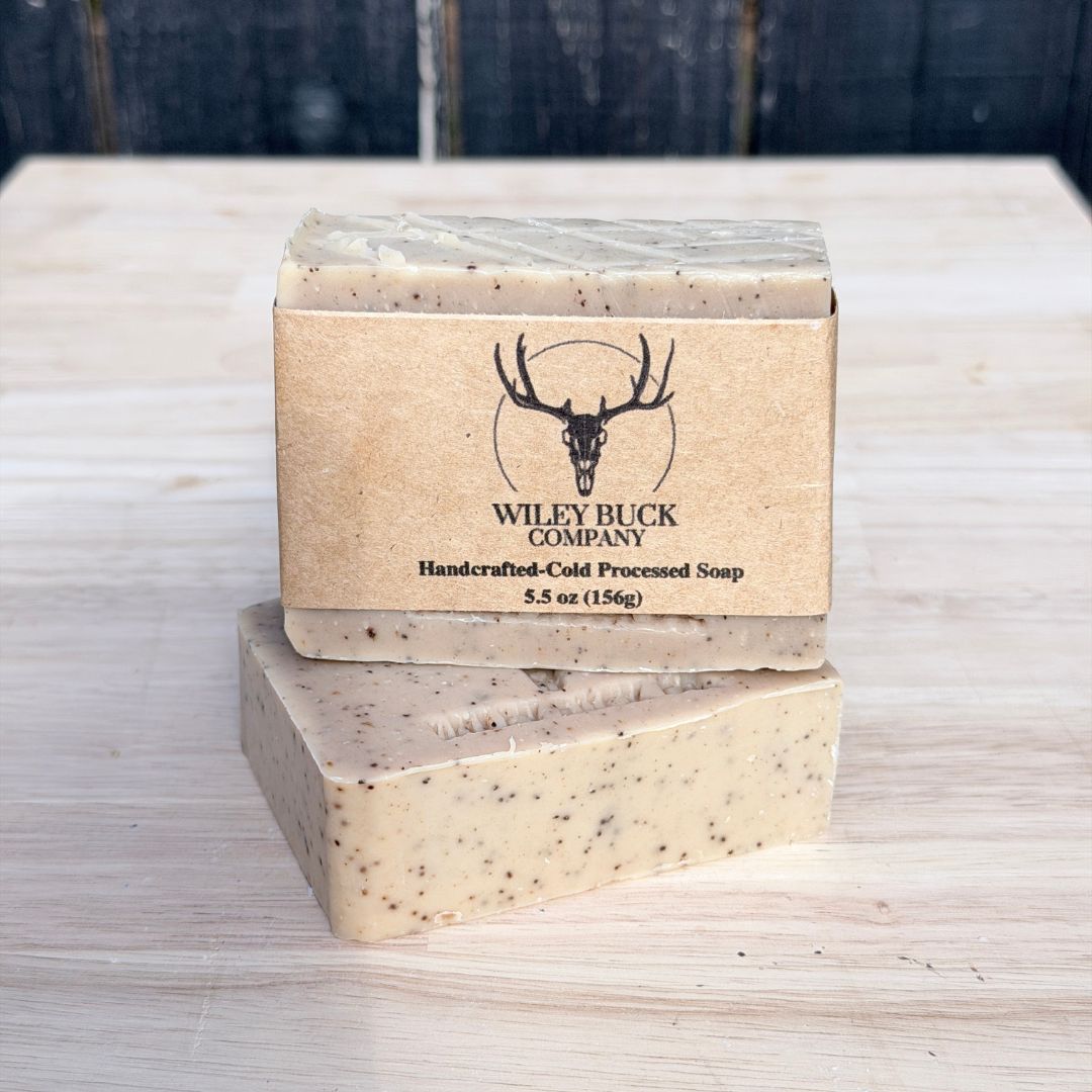 Two bars of soap with a Wiley Buck Company label on a wooden surface.
