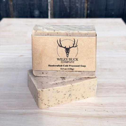 Two bars of soap with a Wiley Buck Company label on a wooden surface.