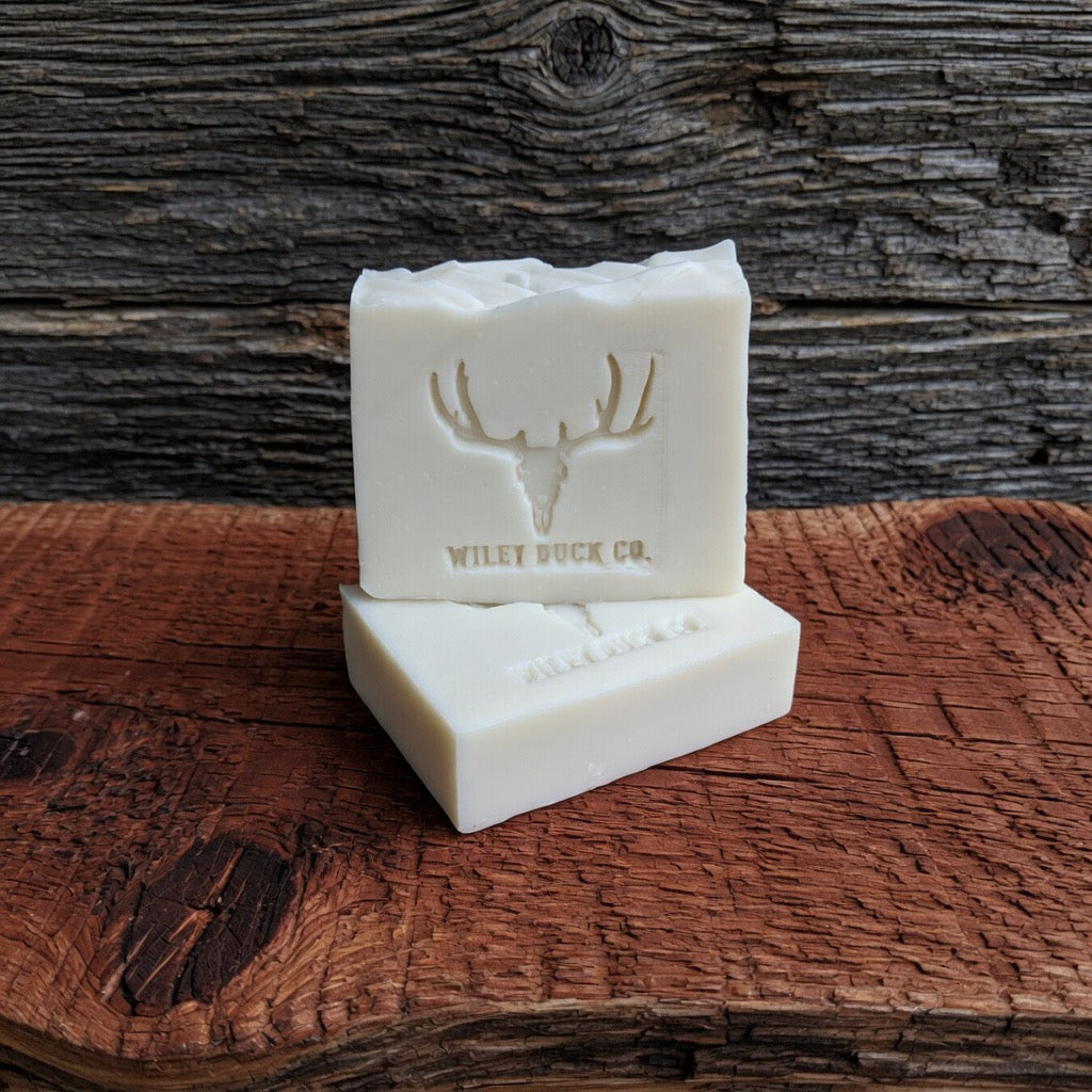 Bar of soap with a deer emblem and 'Wiley Buck Co.' text on a wooden surface