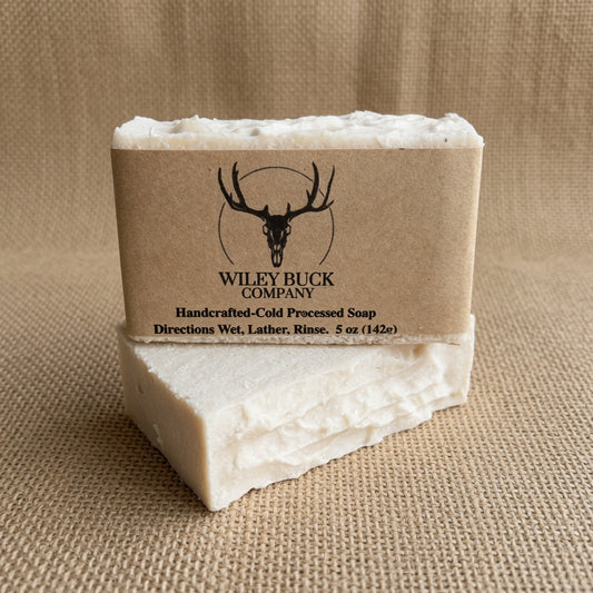 Bar of soap with a brown label featuring a deer logo on a beige background