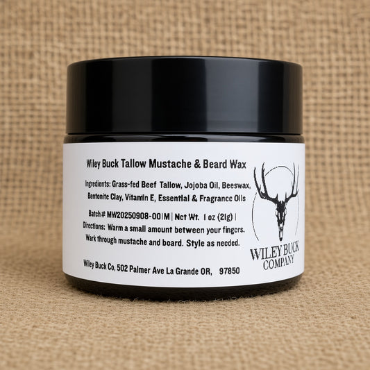 Amber glass jar of Wiley Buck Tallow Mustache & Beard Wax with a white label, set against a textured burlap background.